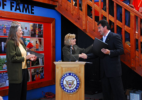 Photo of Senator Boxer handing the award to Director Sal Vaca