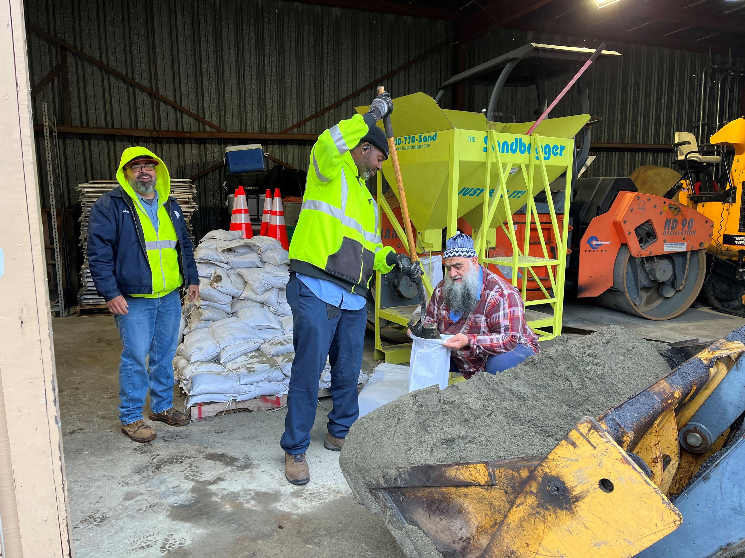 Sandbag - workers filling sandbag for senior guests